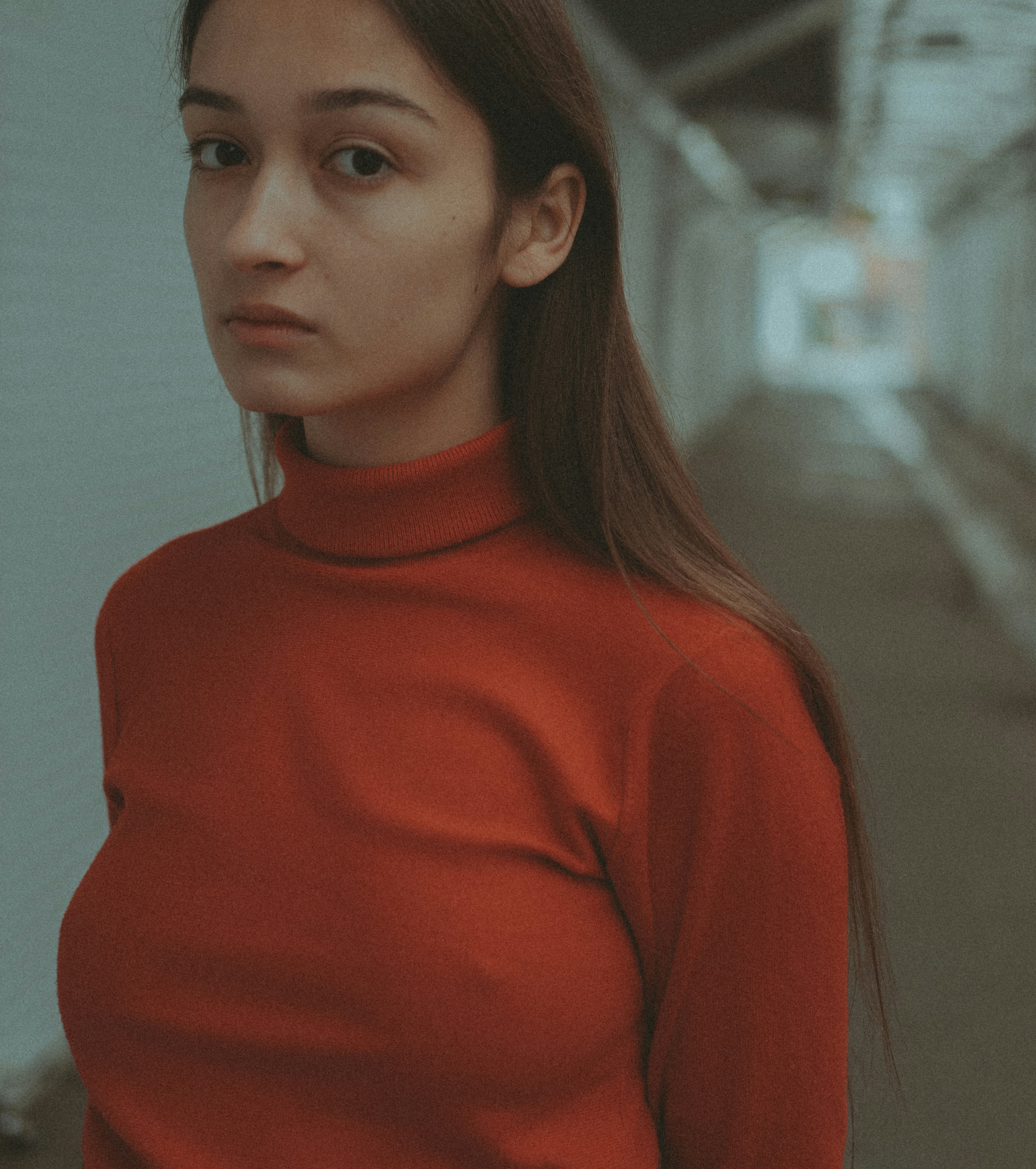 a woman in a red shirt standing in a hallway